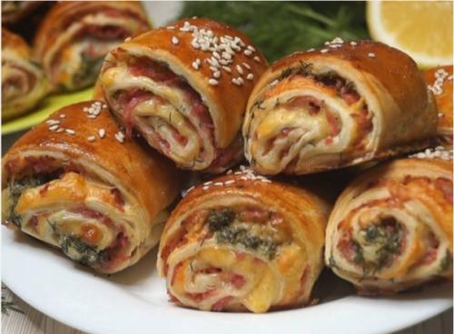 Рулетики из слоеного теста с колбасой и сыром.