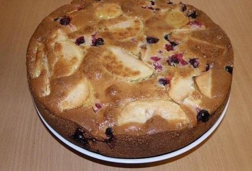 Пышная и румяная шарлотка с яблоками и ягодами.